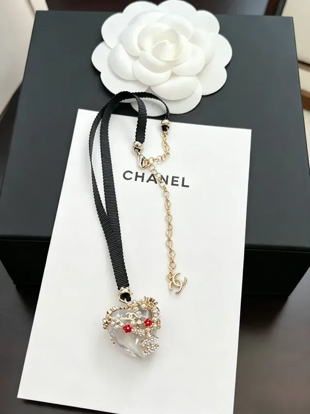 Collar Chanel negro y dorado con colgante de resina en forma de corazón, perlas y adornos florales rojos 9