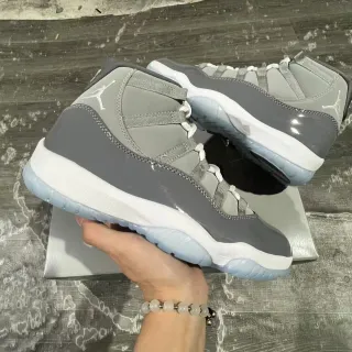 Tênis de basquete cano alto Air Jordan 11 cinza e branco com detalhes em verniz
