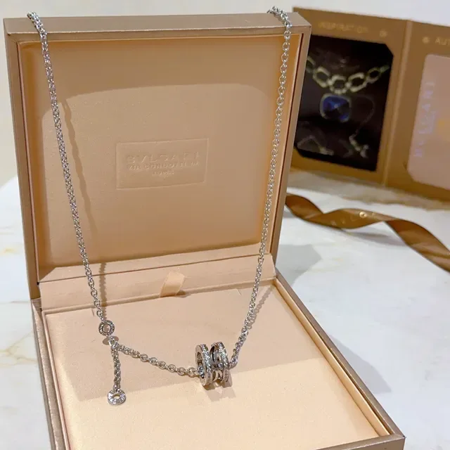 Bvlgari चाँदी सोना मल्टी रिंग घूर्णन पेंडेंट पावे डायमंड एक्सेंट्स नेस्लेस 6