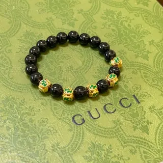 سوارة Gucci سوداء ذهبية خرز كروية