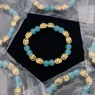 سوار غوتشي Interlocking G بيجيد أكوا وذهبي
