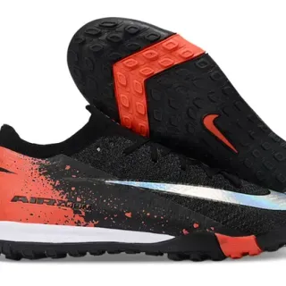 Nike Chaussures de football noir et orange avec upper en knit et semelle turf