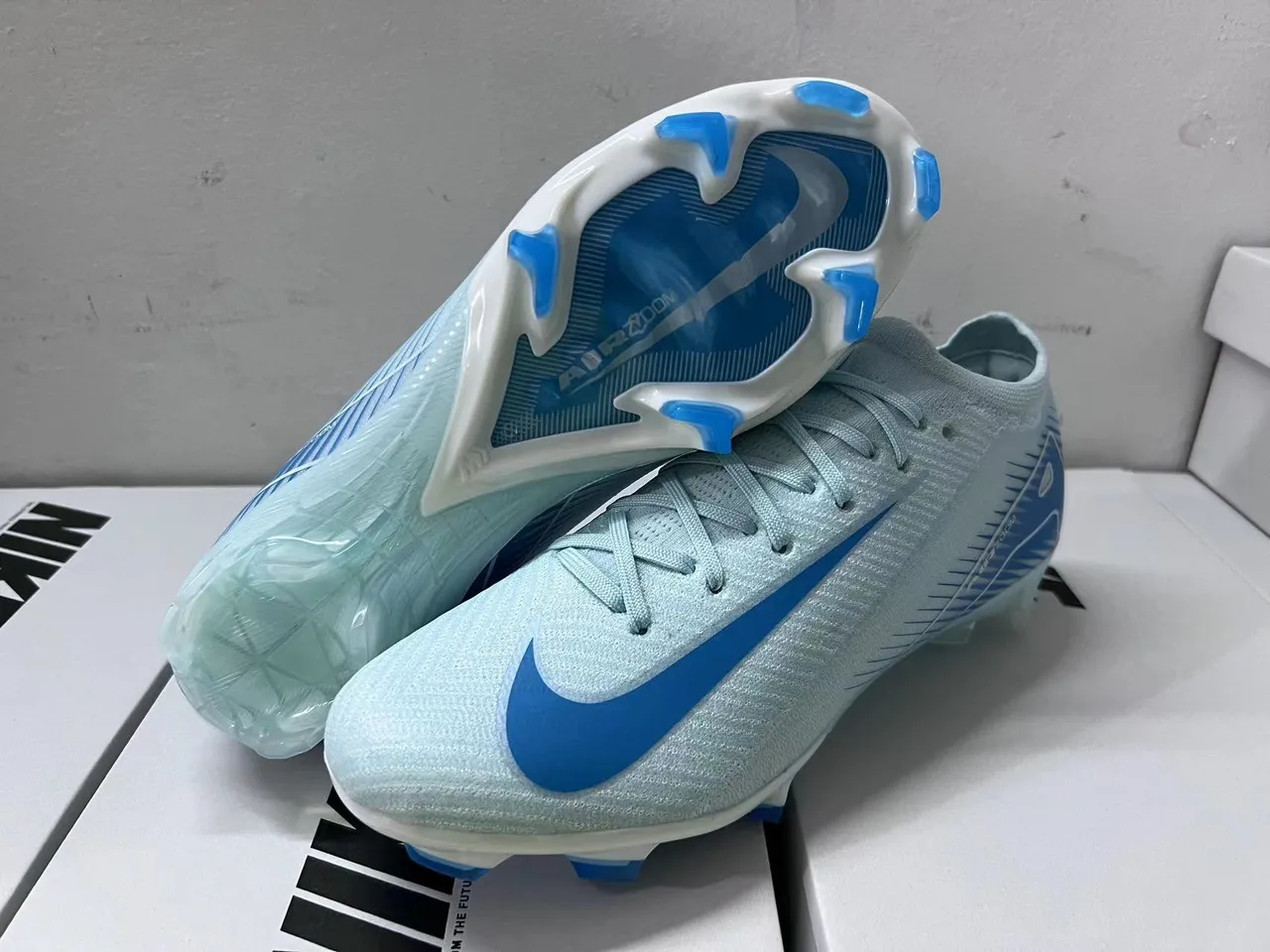 Nike Chaussures de football à tige basse, ajustement chaussette, upper en mesh ingénierisé au style Flyknit-Style, bleu transparent, pour surface ferme 15