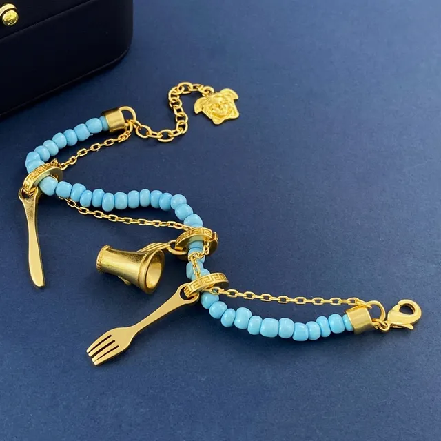 Pulseira azul e dourada adornada com contas e charms 5
