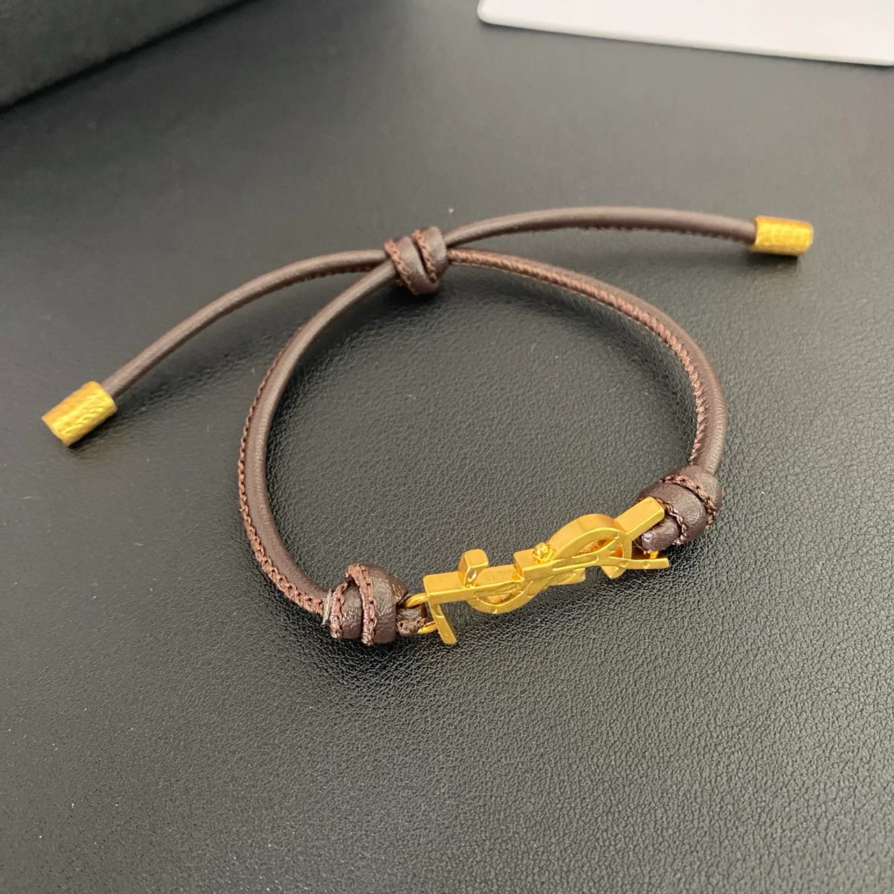 Saint Laurent YSL Monogram Black Brown Interlocking Charm Adjustable Cord Construction Bracelet 5