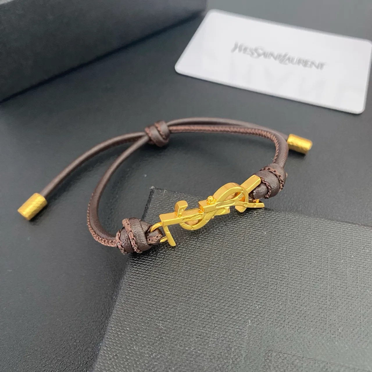 Saint Laurent YSL Monogram Black Brown Interlocking Charm Adjustable Cord Construction Bracelet 7