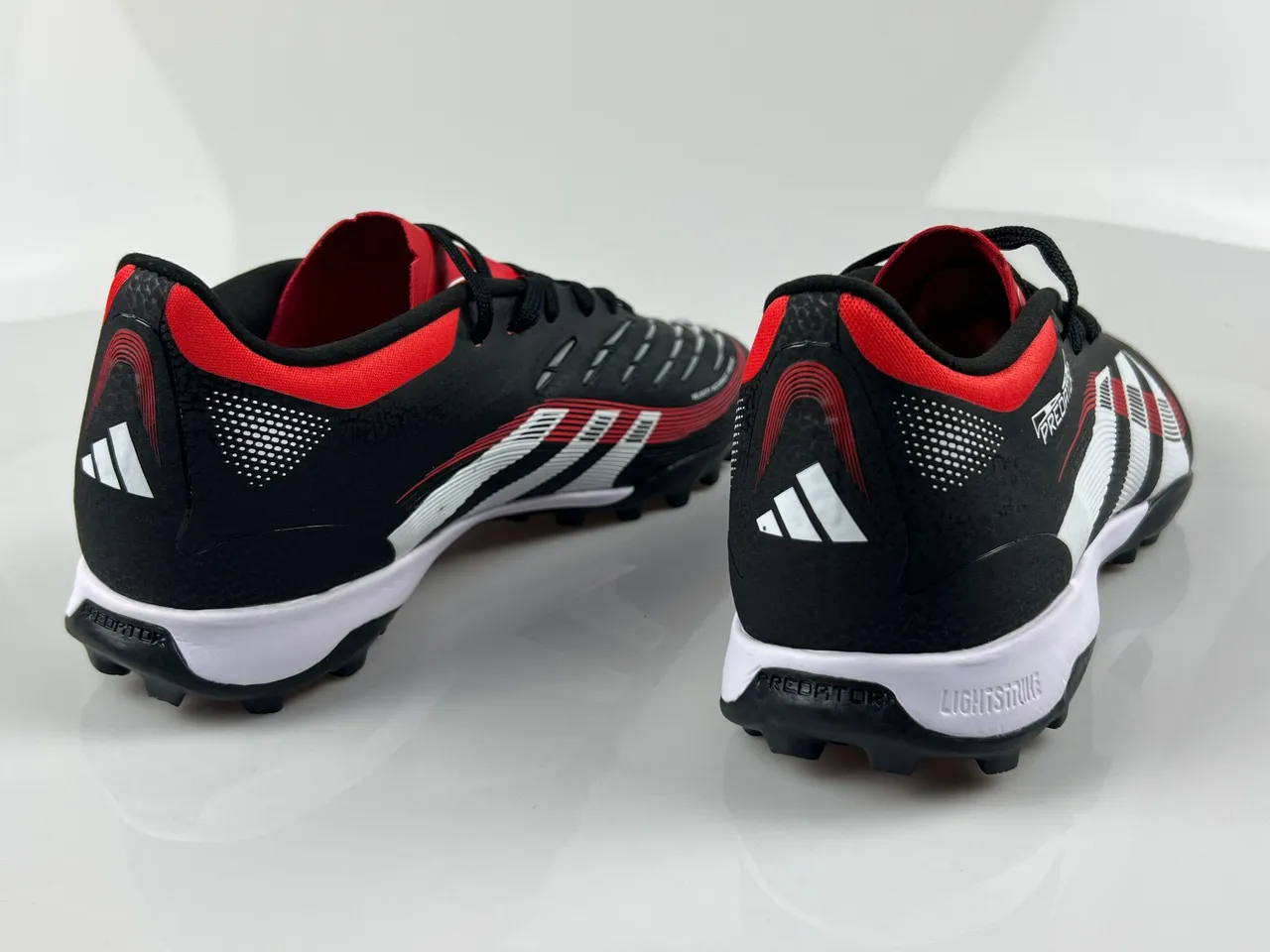 Adidas Predator Zapatos de fútbol turf con upper sintético texturizado negro y rojo, cordones asimétricos 3