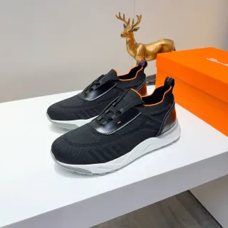 أحذية رياضية سوداء وبرتقالية من الخامة المحبوكة بدون لاسل slip-on