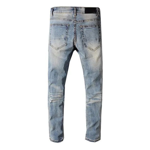 Jeans desgastado azul lavado claro con bajo en bruto 14