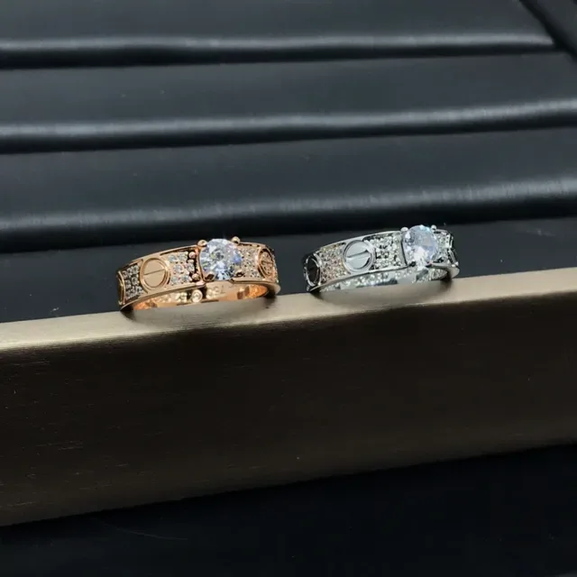 Cartier Love Ring Silver and Gold Pavé Diamond Central Stone Rings 5