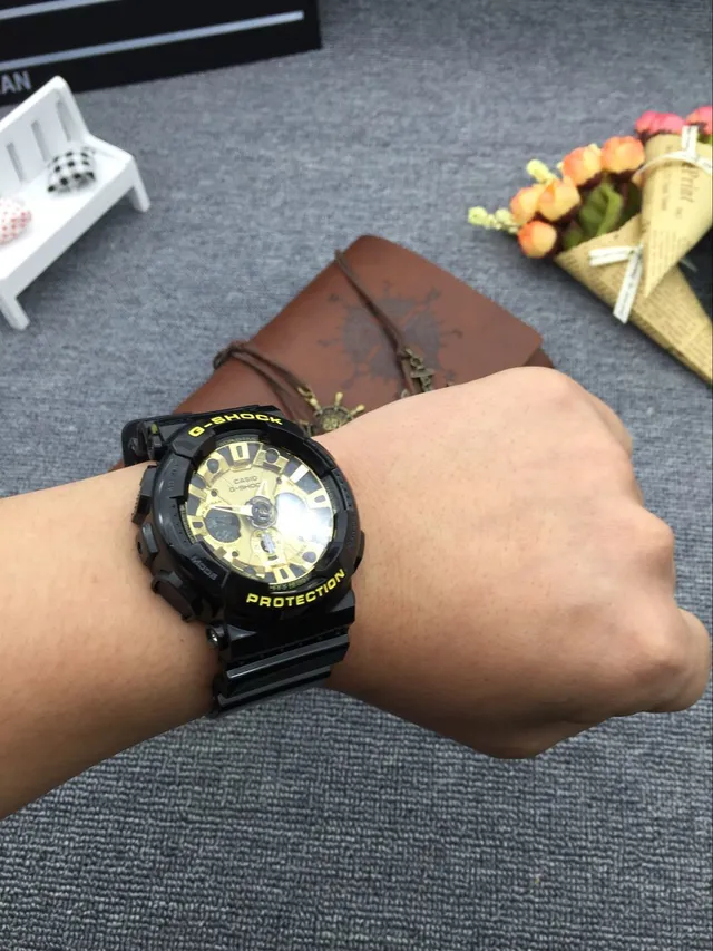 Casio G-Shock GA-100 काली और सुनहरी खेल की घड़ी 6