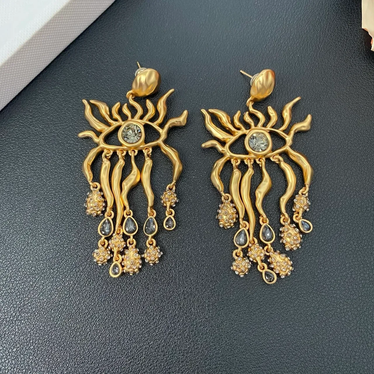 Brincos pendantes de filigrana de chama com motivo de olho em tom dourado 4