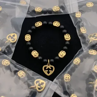سوار Gucci أسود ذهبي خرز interlocking G Logo