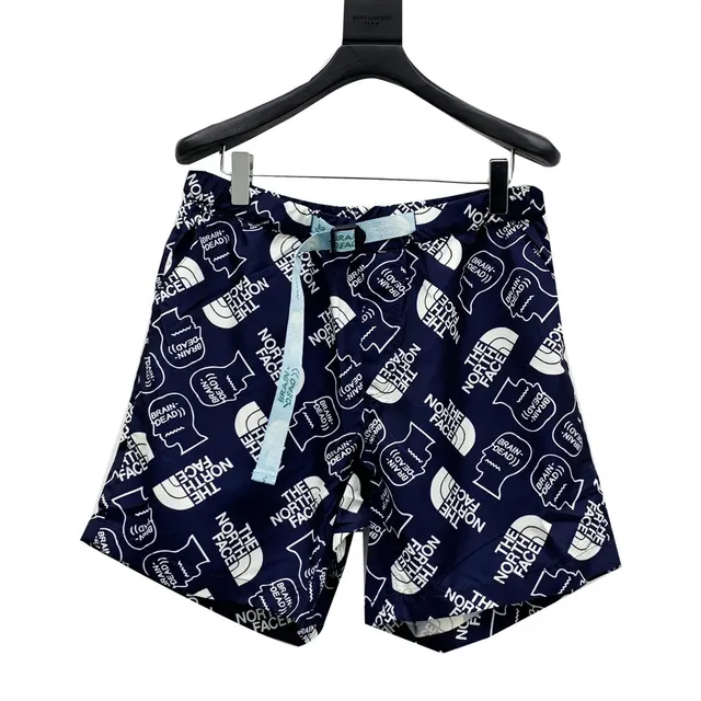The North Face x Brain Dead Pantalones cortos con impresión completa de diseño de colaboración azul marino y blanco 2