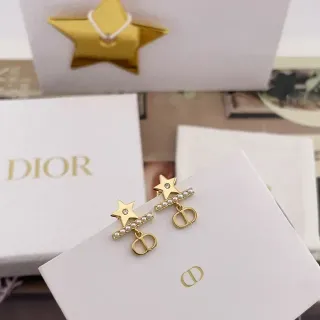 Dior Boucles d'oreilles dorées et blanches en forme d'étoile