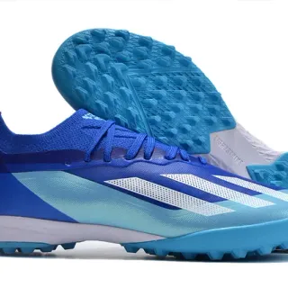 Adidas أحذية كرة القدم منخفضة القطعة من الشبيكة مع أربطة غير متناظرة للعشب الاصطناعي باللون الأزرق
