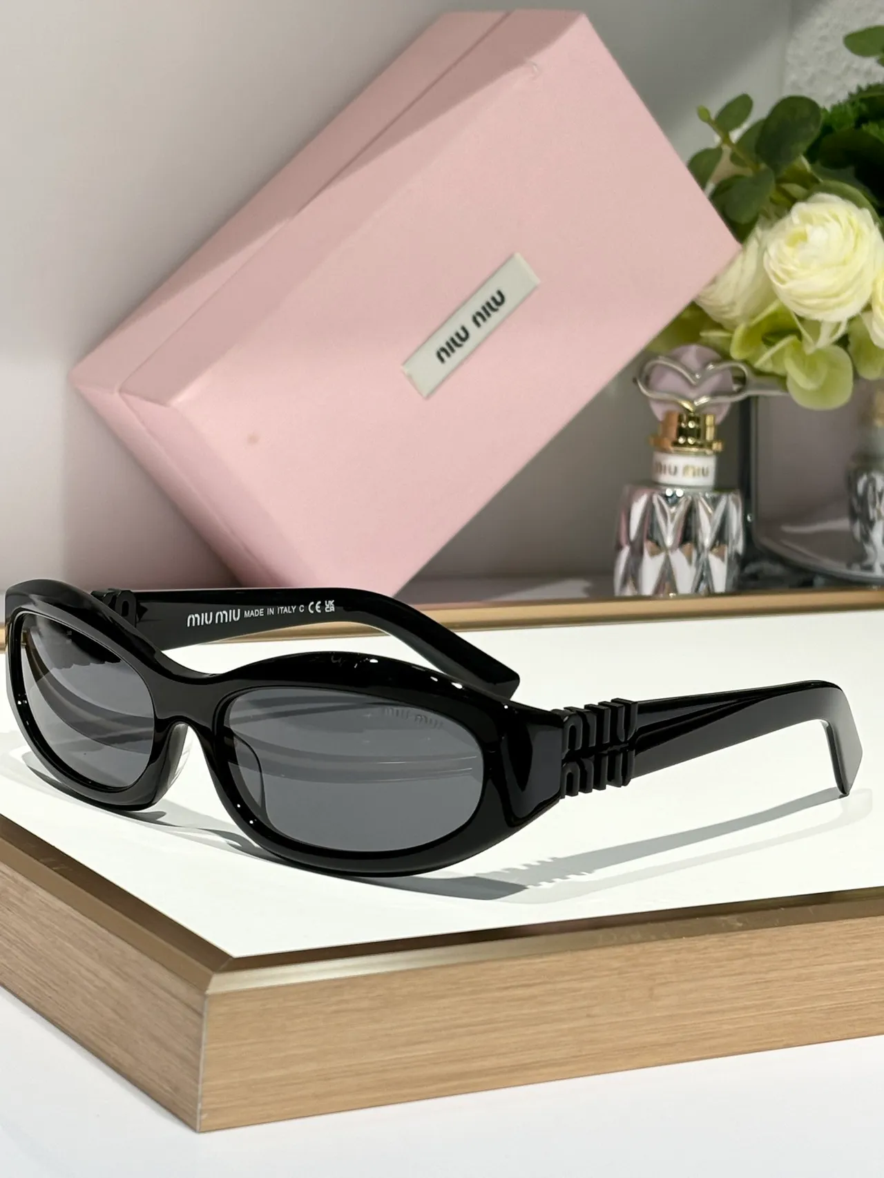 Miu Miu Gafas de sol con marco ovalado rosa y oro, patillas gruesas con logo embossado 4
