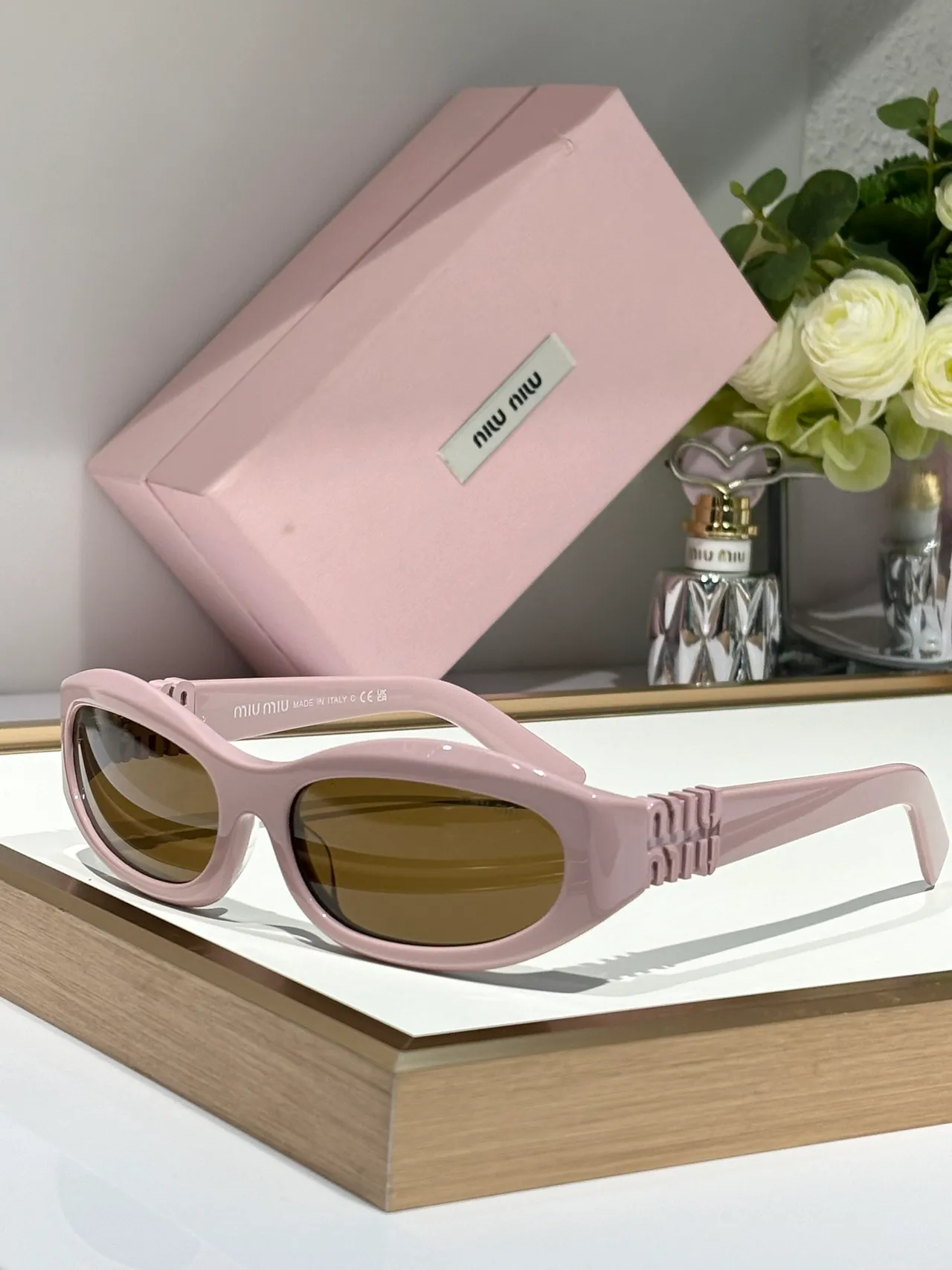 Miu Miu Gafas de sol con marco ovalado rosa y oro, patillas gruesas con logo embossado 7