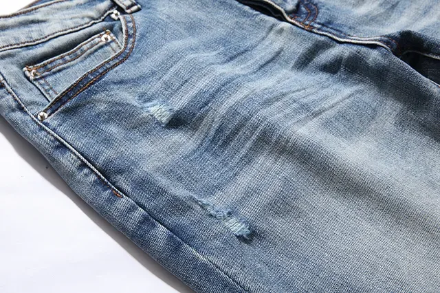 بناطيل جينز أزرق ممزقة مفتوحة الفتق مع قصة slim-tapered 14