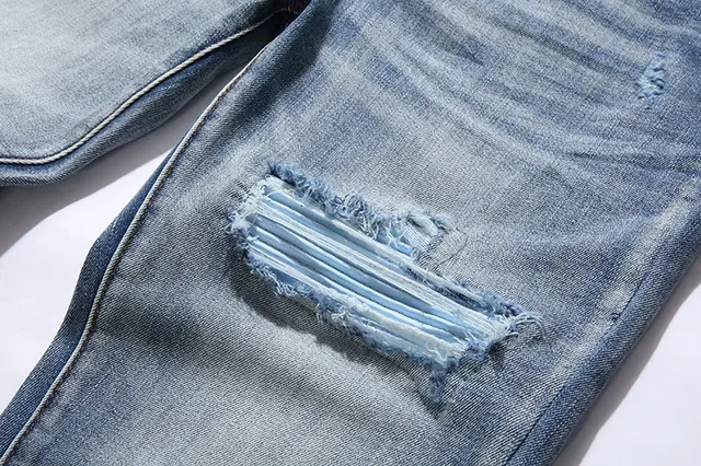 بناطيل جينز أزرق ممزقة مفتوحة الفتق مع قصة slim-tapered 15