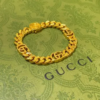 Gucci سوار ذهبي سميك كيرب لينك مع شعارات G متشابكة
