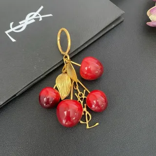 Saint Laurent Cherry Cluster Gold-Tone Resin Brooch — catalogue photo carrying descriptive alternative text