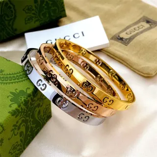 Gucci Bangle Rígido de Oro y Plata con Motivo GG Interlocking