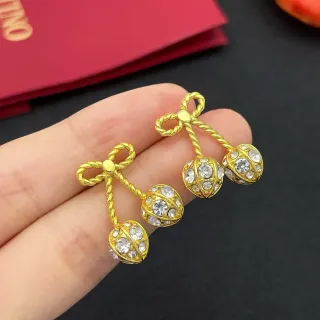 Brincos com laço dourado e cristal de cereja