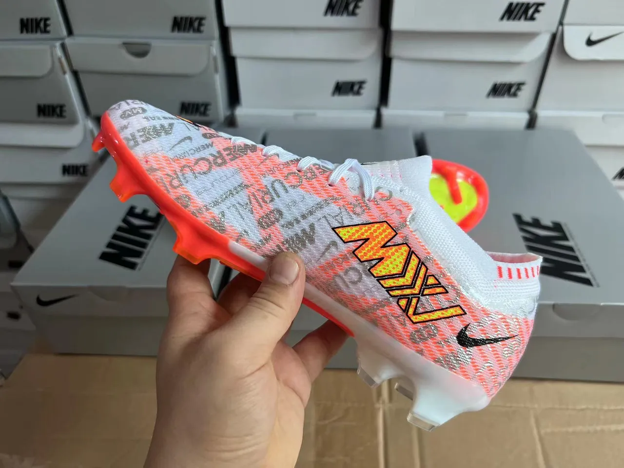Nike chaussures de football blanches et oranges avec upper Flyknit, coupe basse, col de chaussette, terrain ferme 2