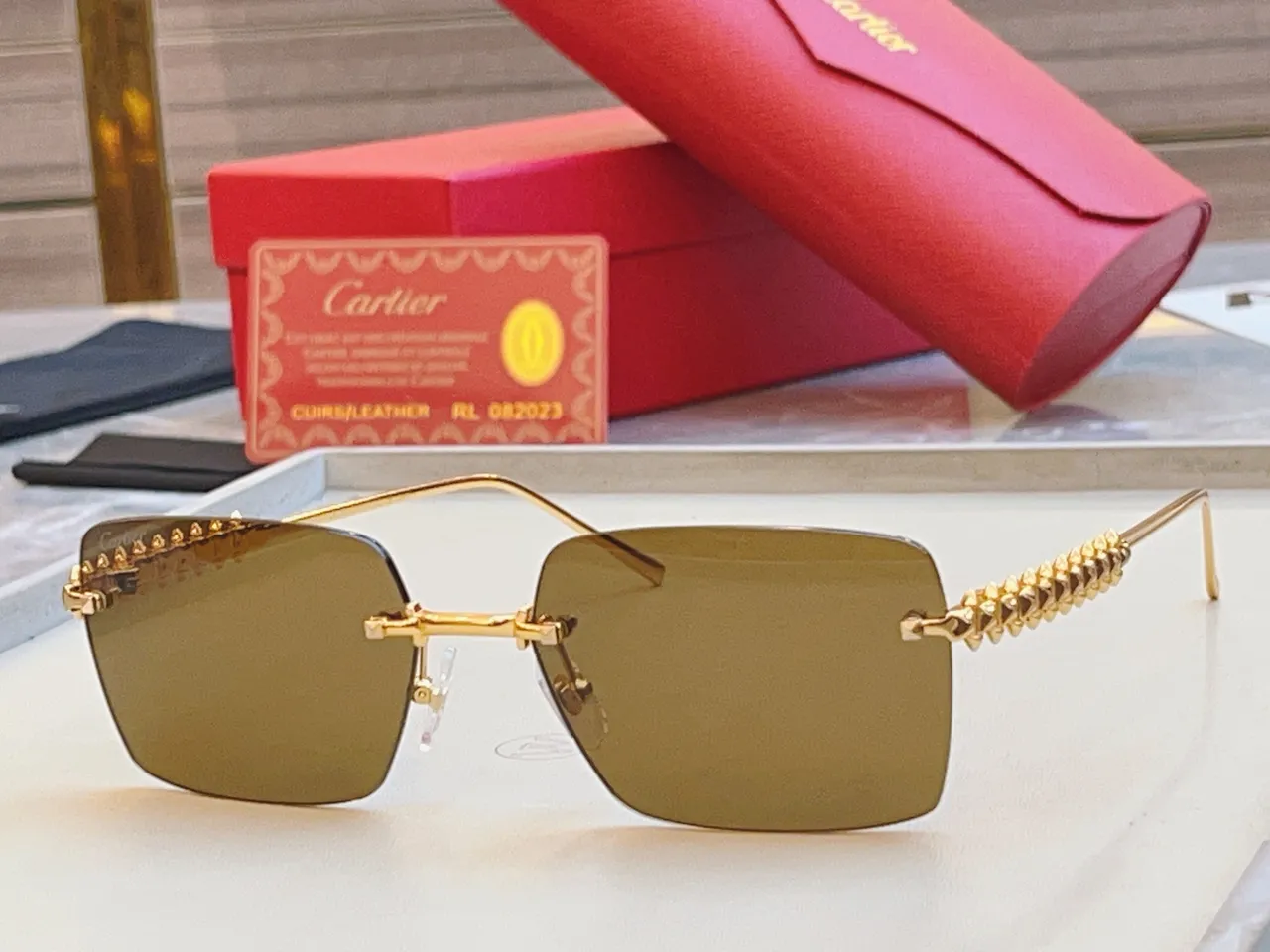 Cartier Lunettes de soleil dorées roses rectangulaires sans bord métalliques 6