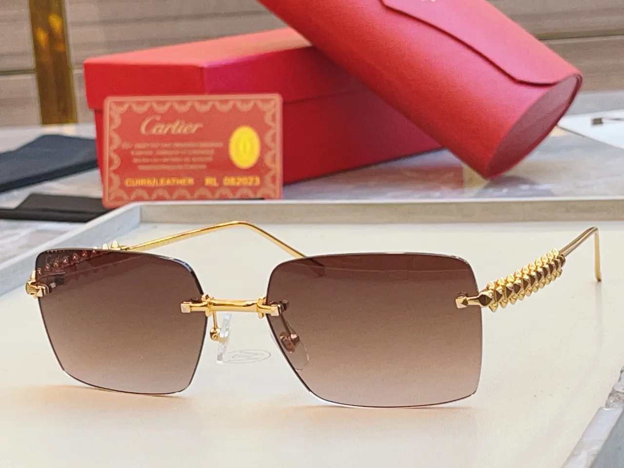 Cartier Lunettes de soleil dorées roses rectangulaires sans bord métalliques 9