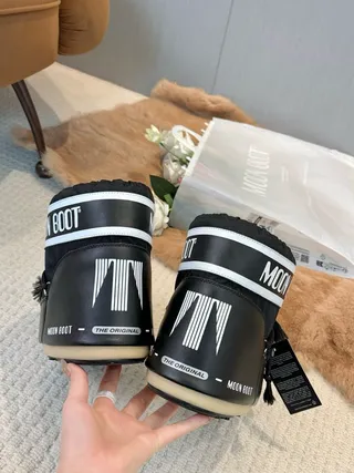 Botas de nieve con cordones aisladas en negro y crema 2