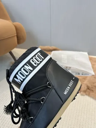 Botas de nieve con cordones aisladas en negro y crema 3
