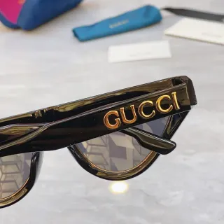 Gucci نظارات شمسية سوداء ذهبية لامعة من الأسيتات مع تفاصيل الشعار