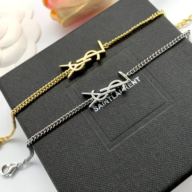 سوارات Saint Laurent Monogram ذهبي وفضي سلسلة 3