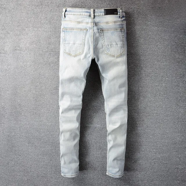 Amiri Calças Jeans Azuis e Brancas Desgastadas com Estampa Gráfica 12