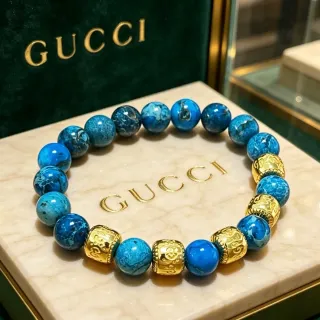 Gucci Pulsera de piedras azules marmoleadas y doradas