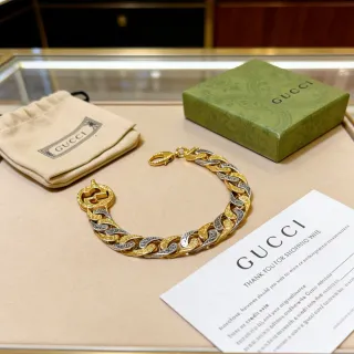 سوار Gucci من الذهب والفضة ذو الرابطين المنحنيين ثنائي اللون