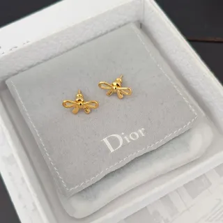 Dior Boucles d'oreilles en forme de nœud en ton doré