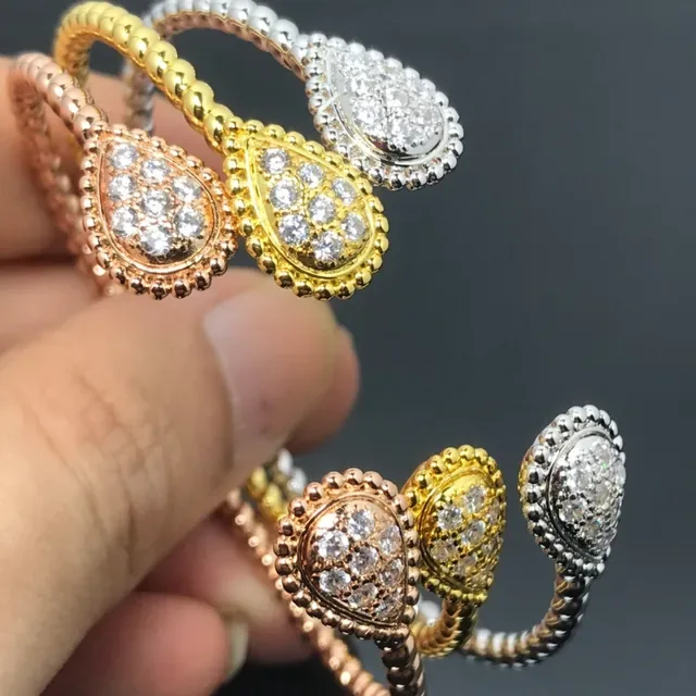 Anneau argent et or tête de larme pavé bande style corde enroulée 2