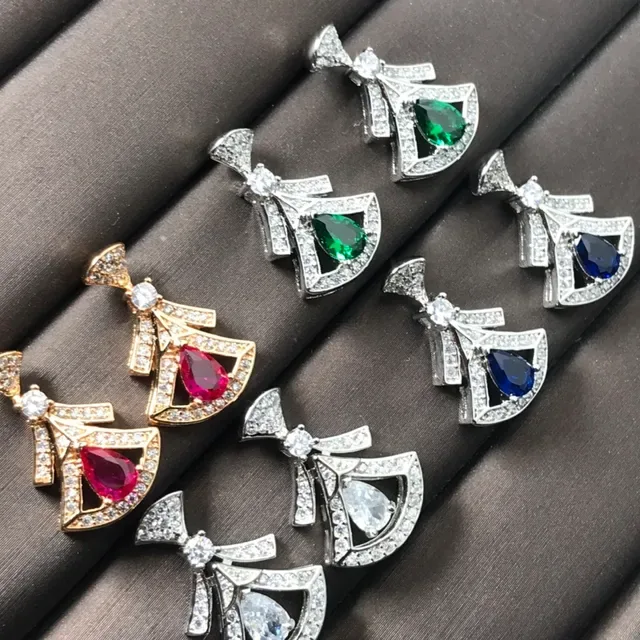 Colgante de joyería con motivo de lazo en tono dorado y plateado y gema en forma de lágrima 2