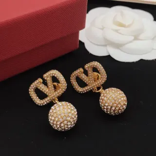 Brincos dourados com cristal pavé geométrico e bola pendente