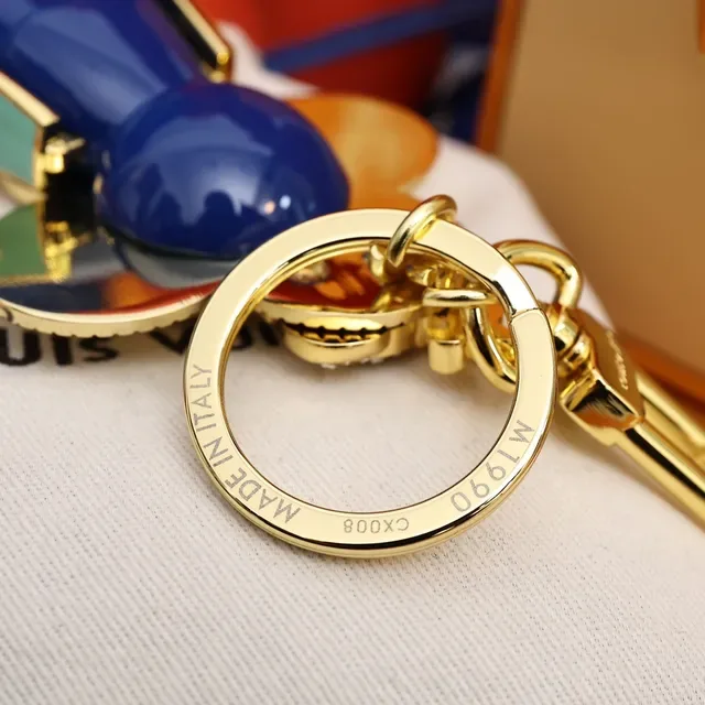 Louis Vuitton Broche avec Charm de Fleur Porte-clés en Or et Cristal Bleu 7